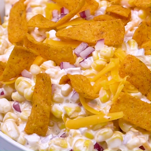 Frito Corn Salad is wonderfully creamy with lots of shredded cheddar cheese and crunchy, salty Frito corn chips. Great for summer potlucks and picnics! Recipe: https://spicysouthernkitchen.com/frito-corn-salad/ | Spicy Southern Kitchen
