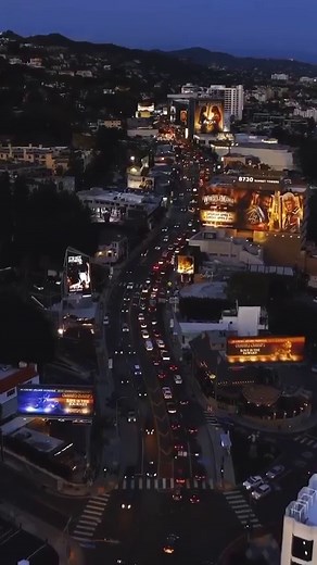 LUMINEX artist Sarah Rara’s ( @raraspeaks ) Reverse Women (2023) seen from the sky (on the left of frame / north side of Sunset Blvd.) Drone footage re-posted from @thesunsetstrip @njaicomo Reverse Women (2023) comes down May 31 / last day to check out! Located at 8743 Sunset Blvd. Commissioned by the City of West Hollywood MIMA. Plays at the top of the hour every hour. #luminex #nowart #luminex2023 #luminexla #nowartla #artandtechnology #southparkbid #immersiveartworks #outdoorexhibition #augme