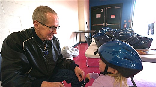 Brain injury survivor on mission, gives 22,000 bike helmets to kids