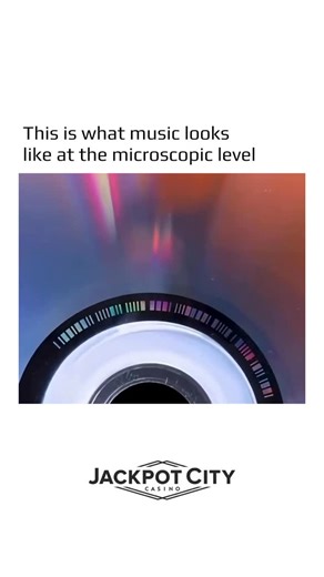 @earthspctr on Instagram: "When you zoom in far enough on a CD, you are not seeing sound grooves like those on a vinyl record – you are seeing pure data. All the music is stored as tiny pits and flat areas arranged in a precise binary pattern of ones and zeros. As the disc spins, a laser scans this surface, reading changes in reflection and translating them back into sound in real time. What makes this even more astonishing is the scale. The laser performing this task is about one sixth the widt