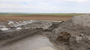 Dense, fluid, heavy and thick muddy water. Mud is soil, loam, silt or clay mixed with water. It usually forms near waters sources. Ancient mud deposits harden over geological time to form sedimentary