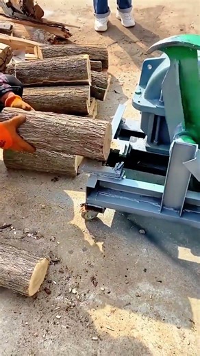 splitting large wooden logs into smaller pieces with an electric log splitter for firewood storage