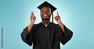 Black man graduation, education and pointing up at college graduate info, college news or university direction. Diploma, studio portrait and student gesture at academy advertising on blue background