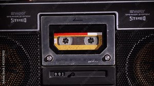 Yellow Audio Cassette in the Tape Recorder Playing and Rotates
