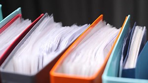 close-up Colorful binders storing important documents filling office shelf