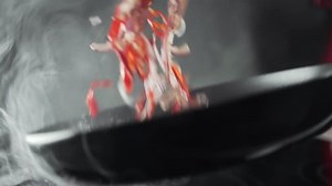 Smoking frying pan with vegetables, chef makes sauce, food cooking, vegetarian food, asian cuisine