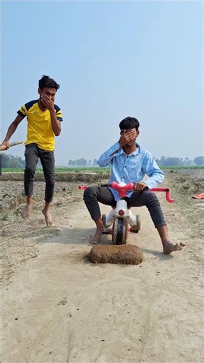 A little boy is having fun with his bicycle.