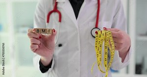 Doctor nutritionist holds word BMI and measuring tape. Body mass index and health