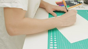 Calligraphy artist writing the word Happy in yellow ink - Free Stock Video