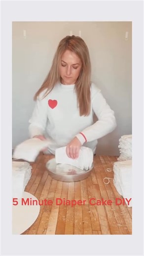 Laura | Small Business Owner | Garden Lover on Instagram: "Quick and Easy Diaper Cake Tutorial #howto #babyshower #partyideas #howtomakeadiapercake"