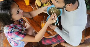 People Eating Delicious Noodles Soup Asian Food, Friends Group Feed Each Other Sit At Table Top Angle View Slow Motion 60