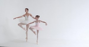 Young female and little girl in a white tutu, dance ballet and perform choreographic elements on a white background, rehearsal.