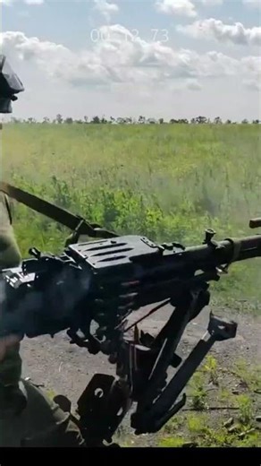 A muscular ex-soldier doing shooting practice with a large rifle