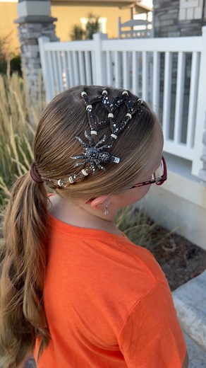 I love a good spiderweb hairstyle at this time of year! With an elastic heavy style like this, you want to clip the elastics out at the end of the night, don’t pull them out. We love our pony pick but you can also use a pair of scissors or small nail clippers. We added some glitter and a spider for an extra fun effect! | Easy Toddler Hairstyles
