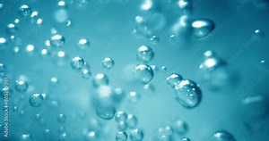 Many water bubbles in blue water close up, abstract water wave with bubbles in slow motion.