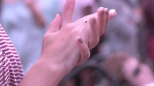 Hands of young girl clapping in slow motion