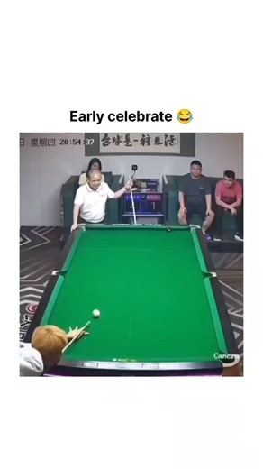 International Reel Hub on Instagram: "The video is a humorous overhead clip from what appears to be a Chinese billiards or pool live stream, showing a middle-aged man in a white shirt confidently taking a shot at a standard green-felt pool table. He leans over, cues up carefully, and strikes the white cue ball, sending an object ball rolling toward a corner pocket with apparent precision. As soon as the ball is on its way, he stands up straight, throws both arms wide open in an exaggerated celeb