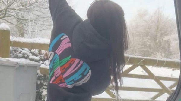 Girl falls on icy road and struggles to get up during a winter walk