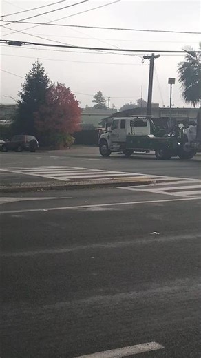The Republic Waste Services trash cart delivery truck is being towed to the transfer station/yard.