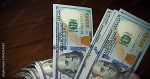 Banknote authentication. Man holds hundred dollar bills in his hands. Cash counting. Hands holds banknotes. Converting cash American dollars. New hundred dollar bills, USD. Cinema 4K 60fps video