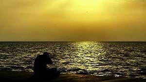 People Silhouette Near the Seaside in Sunset