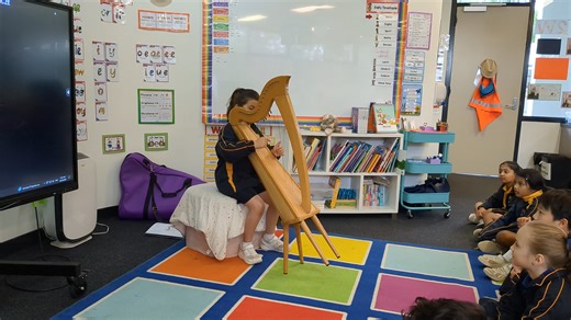 Colette plays harp to her class 2W