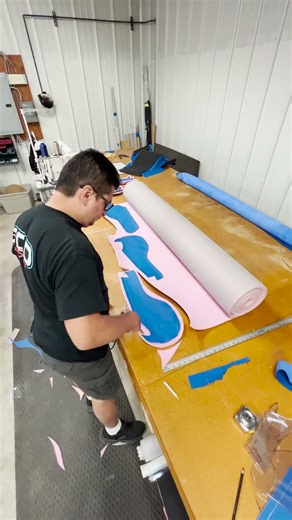 Julio laying out his leather patterns, preparing to cut