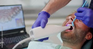 Closeup of a dentist performing a 3D dental scan on a patient in a dental office