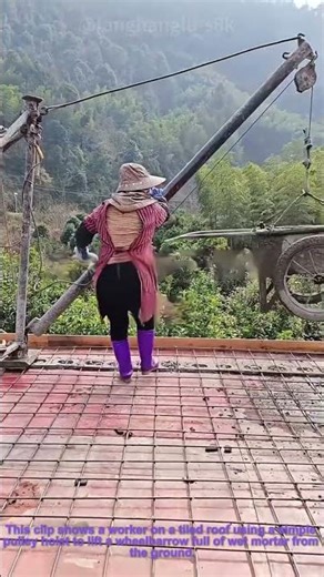 Roof Mortar Work: Worker Using Hoist to Lift Materials