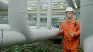 Petroleum refinery service worker, Oil and Gas outdoor pipes and valve inspector, Gas leak checking video slow motion