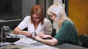 Close up hand choosing color from color sample swatch. The designer works with the customer and recommends the colors of decorative coatings.