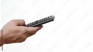Television remote control in the hands of a person pointing to TV and changing channels. Close up of a person holding controller and pressing the button isolated on white background.