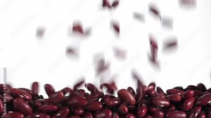 Red beans fall in slow motion and cover the whole screen