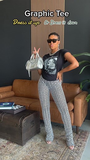 Transform your graphic tee from casual to chic with these simple styling tips! Dress it up with a tuckin to shape your body and heels or dress it down with sneakers and denim. Try it out now and elevate your wardrobe game! #graphicteeoutfit #outfitideas #outfitideas #howtostyleoutfits