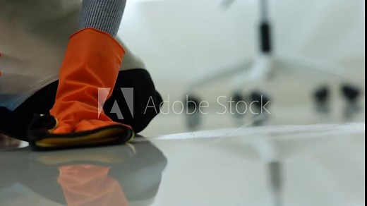 Housekeeping, spray bottle and woman cleaning a table with a sponge in the kitchen at home. Female maid, cleaner or housewife wipe the countertop for dirt, bacteria or dust with sanitizing detergent.