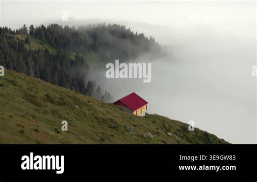 Highland houses stand above clouds with mountain valley views, green meadow remote rural scenery. Upland homes overlook sea of mist across open pasture, elevated settlement scene soft atmosphere. clouds mountain, forest, village Stock Video Footage - Alamy