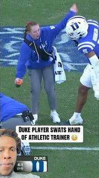 Duke player seats hand of athletic trainer