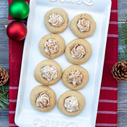 Buttery thumbprint cookies filled with a sweet, slightly boozy icing and dusted with nutmeg. These festive EGGNOG THUMBPRINTS should be on your holiday baking list! GET THE RECIPE: https://www.fromvalerieskitchen.com/eggnog-thumbprints/ | Valerie's Kitchen