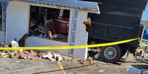 Dump truck crashes into building