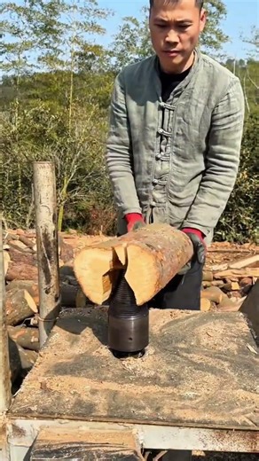 Turning a long wooden pole on a rotating lathe to shape it smoothly for further use later process