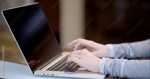Woman typing on a laptop computer