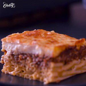 Experience the rich and comforting tastes of Greece with our authentic Greek Pastitsio. It features tantalizing layers of pasta, savory meat sauce, and luscious bechamel sauce. Baked to golden perfection, this traditional dish is a true taste of Greece. | Home Cooking Adventure