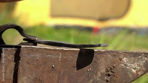 Blacksmith working metal with hammer. Blacksmiths make machete. The man in ancient Russia. Old Russian profession. Smith. The strong man works at a glade.