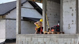 Download Professional Construction Worker Working on Concrete Wall for free