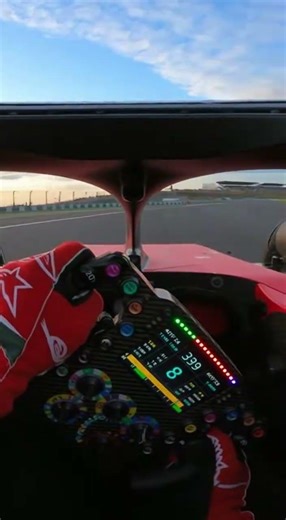 first person POV inside a Formula 1 cockpit driver steering through a high speed corner at 300 km/h