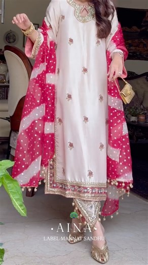 Mannat Sandhu Randhawa on Instagram: "Introducing ‘AINA ’ 🦚 A captivating pristine ivory ensemble. This exquisite ensemble boasts a meticulously hand-embroidered pure silk shirt, adorned with exclusive and intricate embellishments on both its front and back. 🦚 Complementing this shirt are hand-embroidered ivory pants, featuring a graceful shape at the hem that is certain to elevate your presence. 🦚 To complete this enchanting look, we’ve included a stunning red & ivory shade mukaish organza d