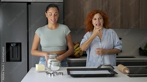 Mother and daughter explaining butter cookies recipe with sign language.
