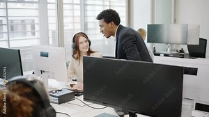 A corporate environment that fosters teamwork and professionalism through collaboration among diverse staff using computers, promoting a culture of collaboration and mutual support