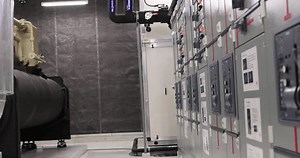 Electrical engineer with green uniform checking and inspecting at MDB panel or Main Distribution Boards of factory