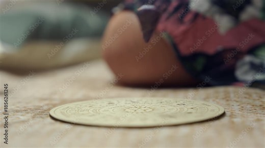 Close-up of woman using a pendulum. Esoteric mood, dowsing focus